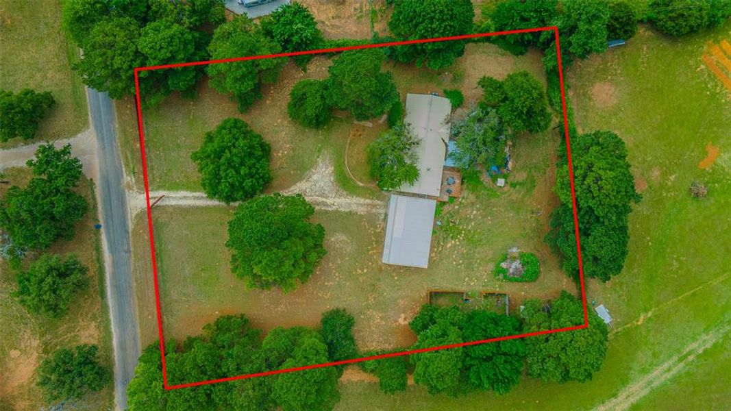 Aerial view highlighting the home's acreage, mature trees, workshop, and peaceful rural setting. Aerial view highlighting the home's acreage, mature trees, workshop, and peaceful rural setting.