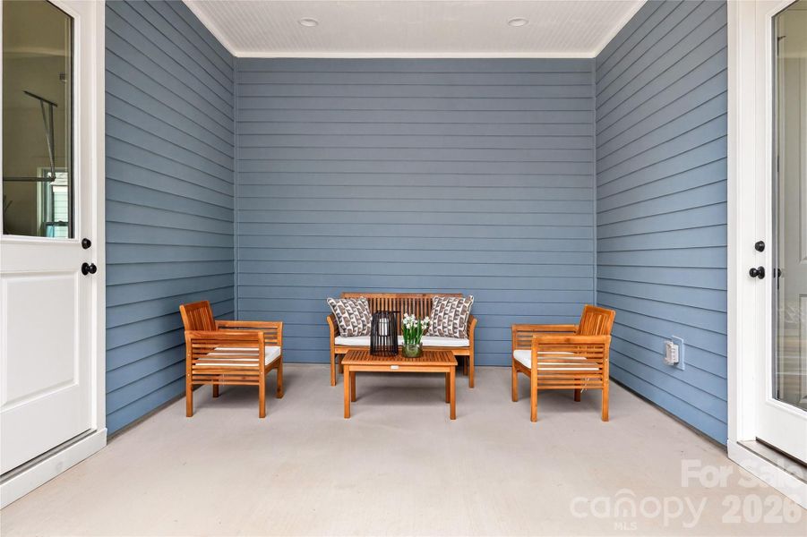 A convenient side porch connects the house to the garage, providing privacy and protection from the weather elements.