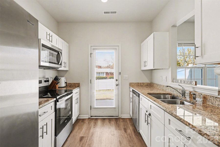 Galley kitchen with open area to dining room.  Soft close cabinets and refrigerator.