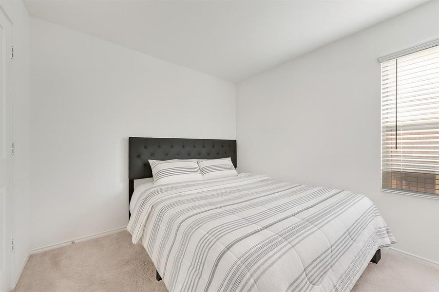 Carpeted bedroom featuring baseboards Carpeted bedroom featuring baseboards