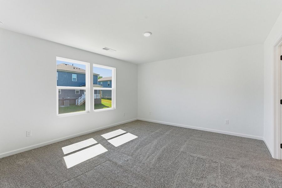 A room with white walls and a window.