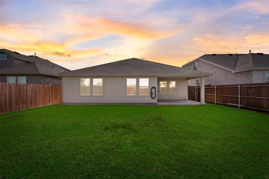 Ranch-style home with roof with shingles, concrete driveway, a front yard, brick siding, and an attached garage Ranch-style home with roof with shingles, concrete driveway, a front yard, brick siding, and an attached garage