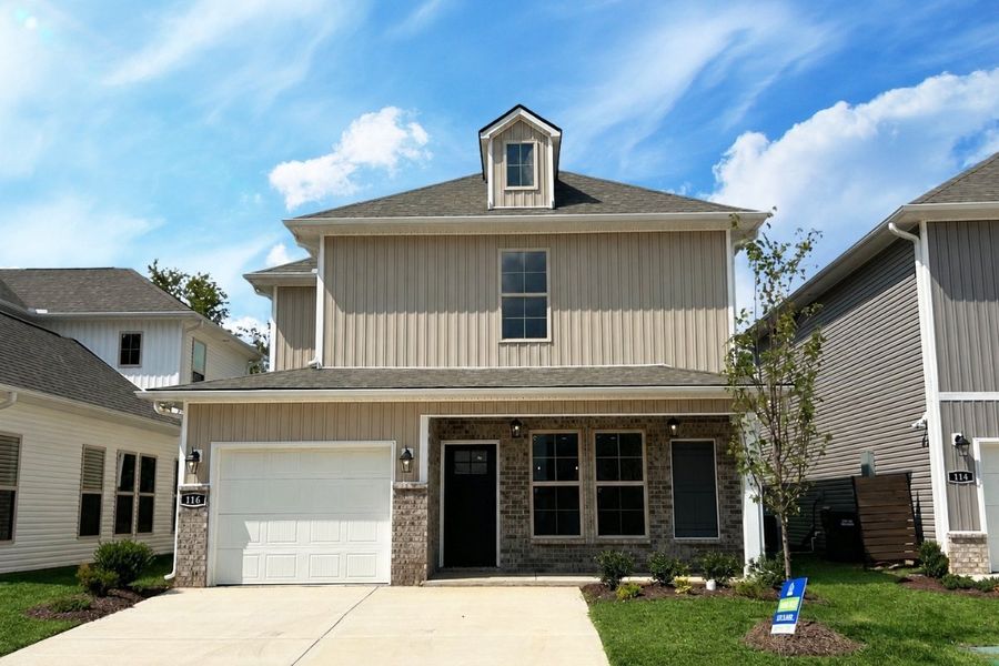 Front exterior of a new home in Hickory Cove, Burns, TN, highlighting curb appeal (Image 2). Front exterior of a new home in Hickory Cove, Burns, TN, highlighting curb appeal (Image 2).