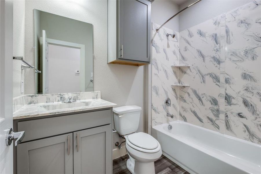 Similar home: Full bathroom featuring vanity, toilet, and tub / shower combination