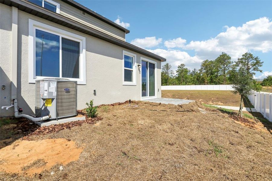 Front exterior of a new home in Cyrene at Minneola - Villas, Minneola, FL, highlighting curb appeal (Image 2).