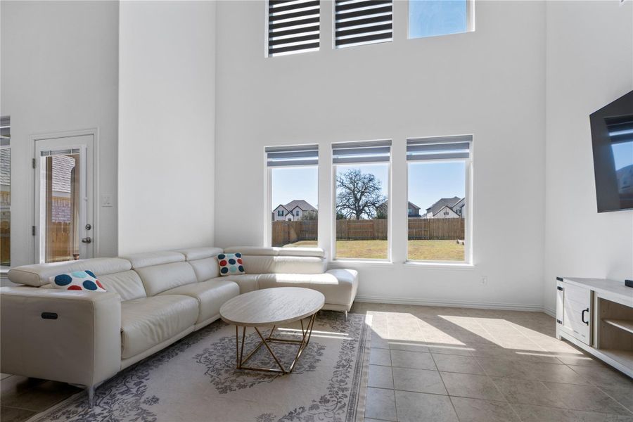 A lofty living area with towering windows brings in abundant natural light. A lofty living area with towering windows brings in abundant natural light.