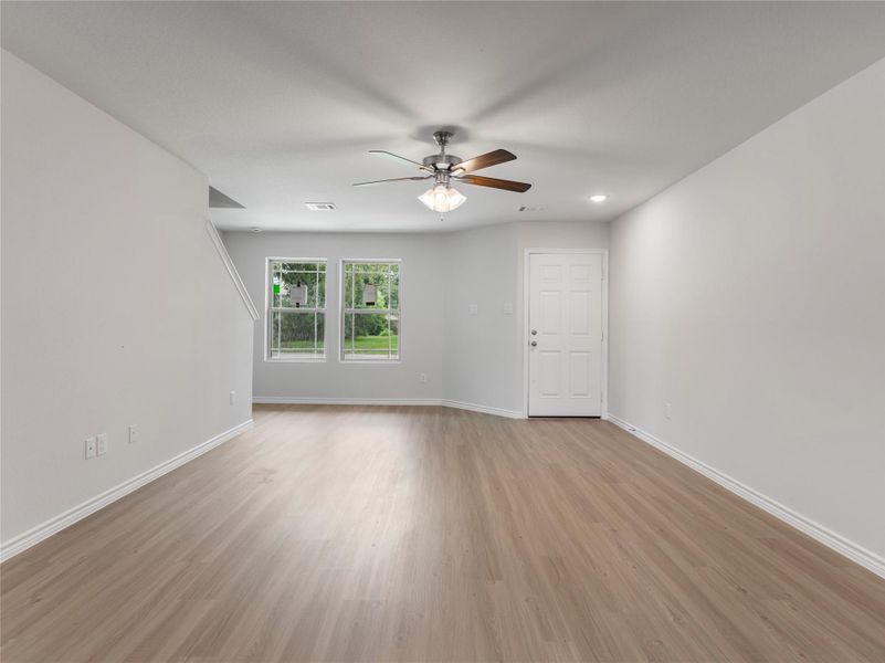 Bright and airy living area enhanced by a stylish ceiling fan.