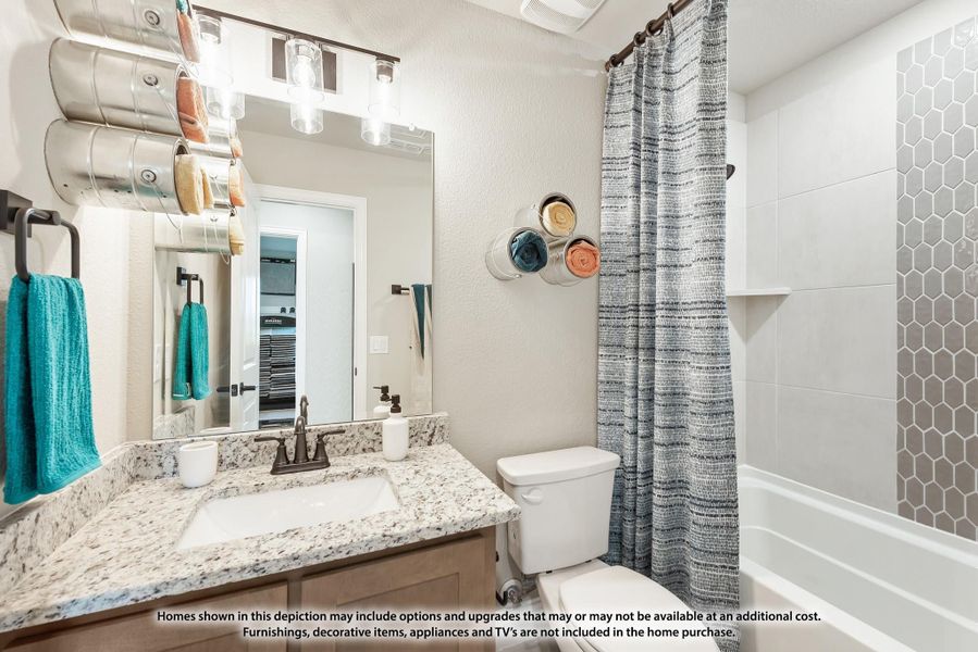 Bathroom with granite vanity, large mirror, and tub-shower combo with hexagon tile surround Bathroom with granite vanity, large mirror, and tub-shower combo with hexagon tile surround