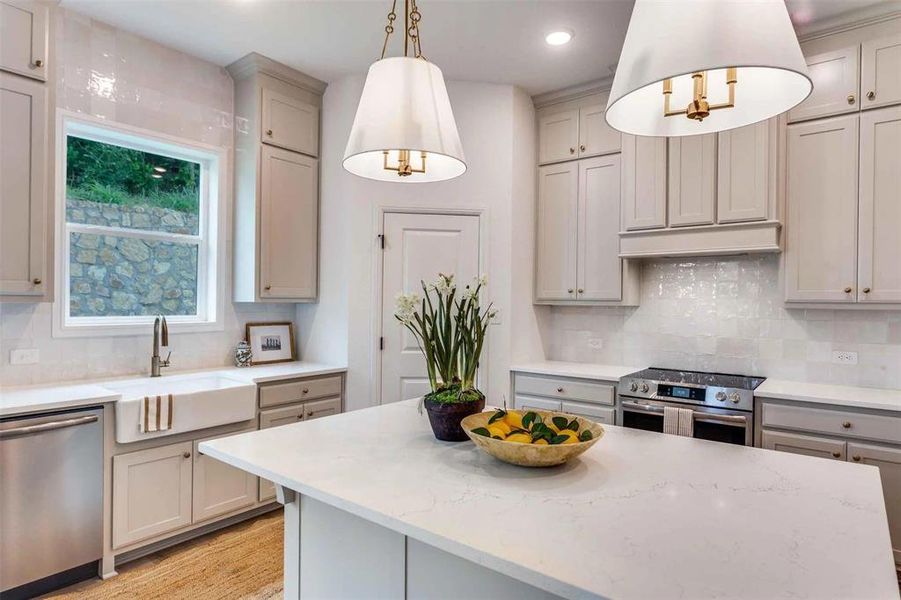 Kitchen featuring backsplash, appliances with stainless steel finishes, light stone countertops, gray cabinets, and recessed lighting