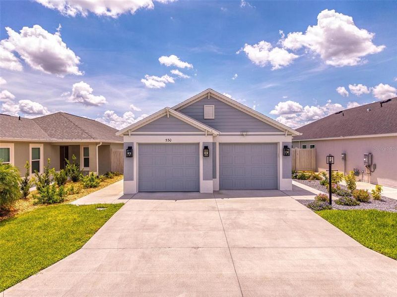 Front exterior of a new home in , The Villages, FL, highlighting curb appeal (Image 24).