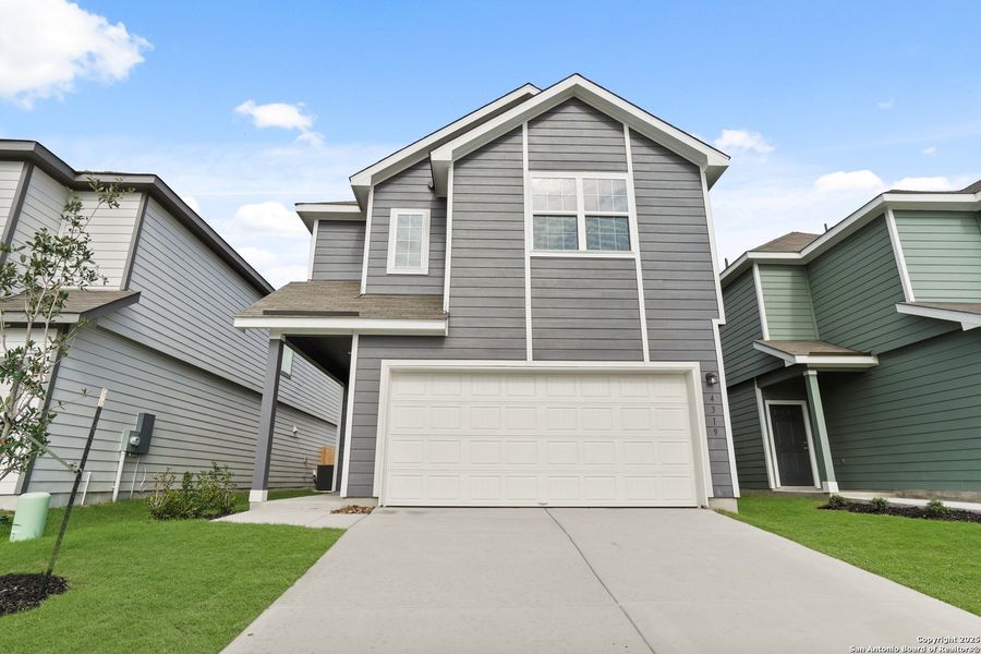 Front exterior of a new home in Melissa Ranch, San Antonio, TX, highlighting curb appeal (Image 1).