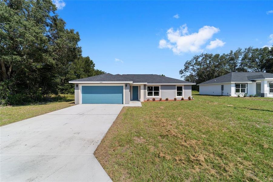 Front exterior of a new home in , Dunnellon, FL, highlighting curb appeal (Image 14).