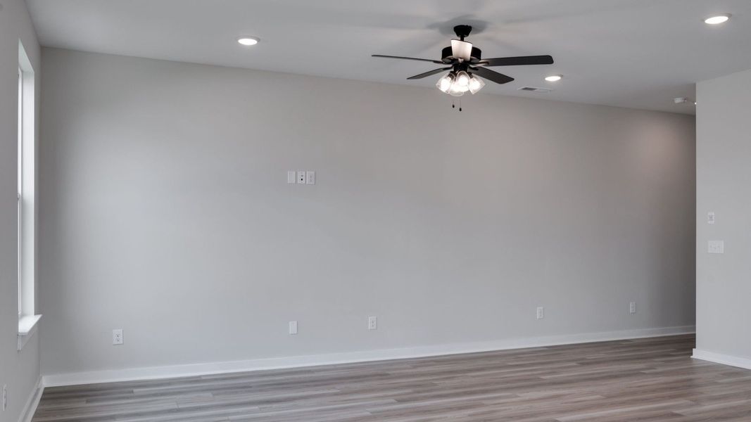 Living area next to kitchen and dining areas