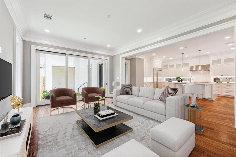 The heart of the home!  The family room/den invites family and friends to gather and is open to the island centered kitchen and also has sliding doors to the beautiful outdoor space and covered patio!   This photo has been virtually staged.