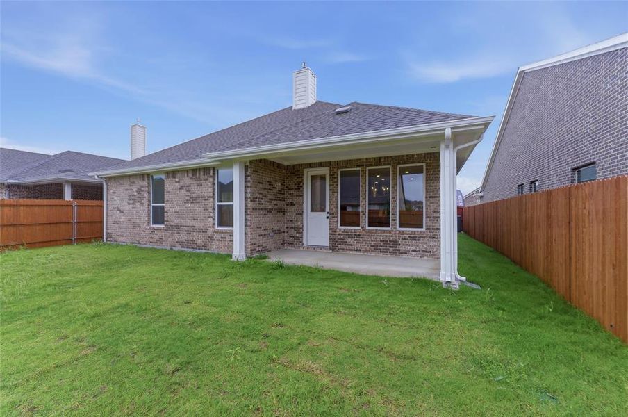 Expansive grassy yard area with a covered patio