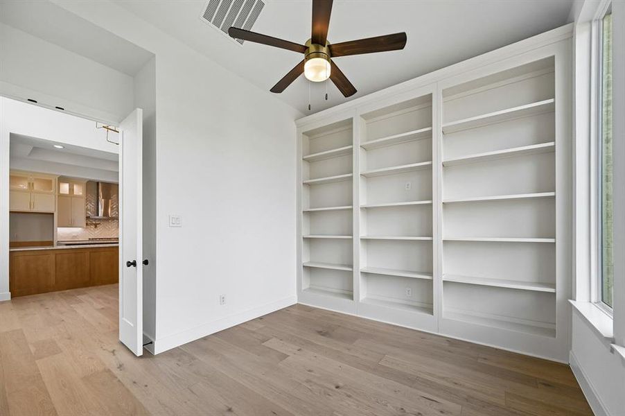 Unfurnished room featuring light wood-style floors and a ceiling fan Unfurnished room featuring light wood-style floors and a ceiling fan
