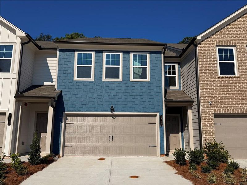 Front exterior of a new home in Laurelwood, Douglasville, GA, highlighting curb appeal (Image 1).