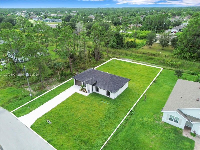 Front exterior of a new home in , Lehigh Acres, FL, highlighting curb appeal (Image 18).