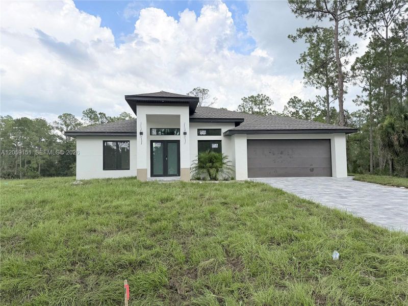 Front exterior of a new home in , Lehigh Acres, FL, highlighting curb appeal (Image 17).