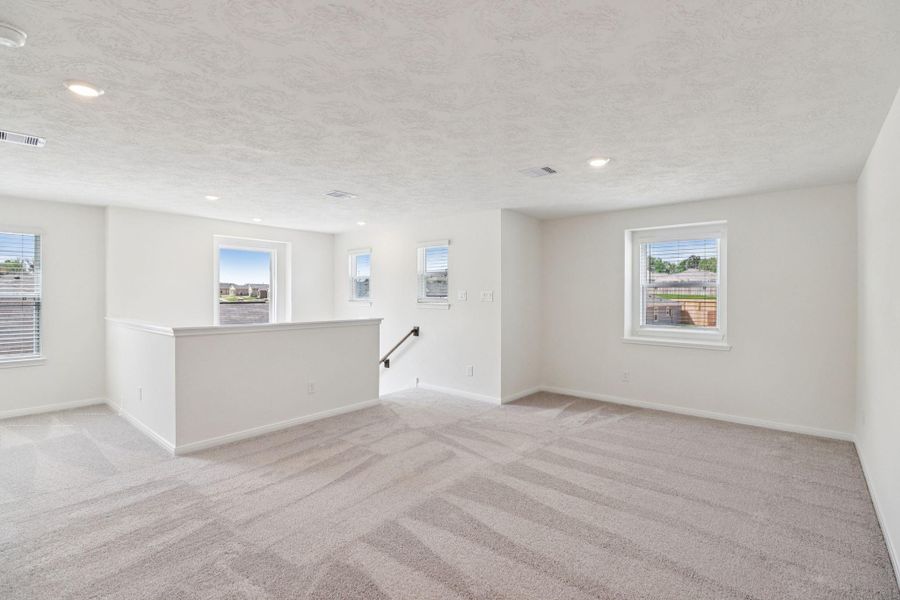 Come upstairs to the second floor with a game room, primary suite, secondary bedrooms and bathrooms.