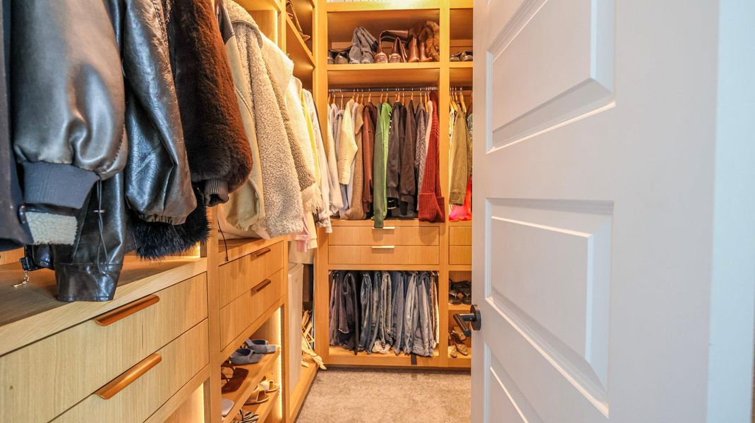 Ample built-in storage solutions and thoughtful recessed lighting outfit this spacious walk-in closet. Ample built-in storage solutions and thoughtful recessed lighting outfit this spacious walk-in closet.