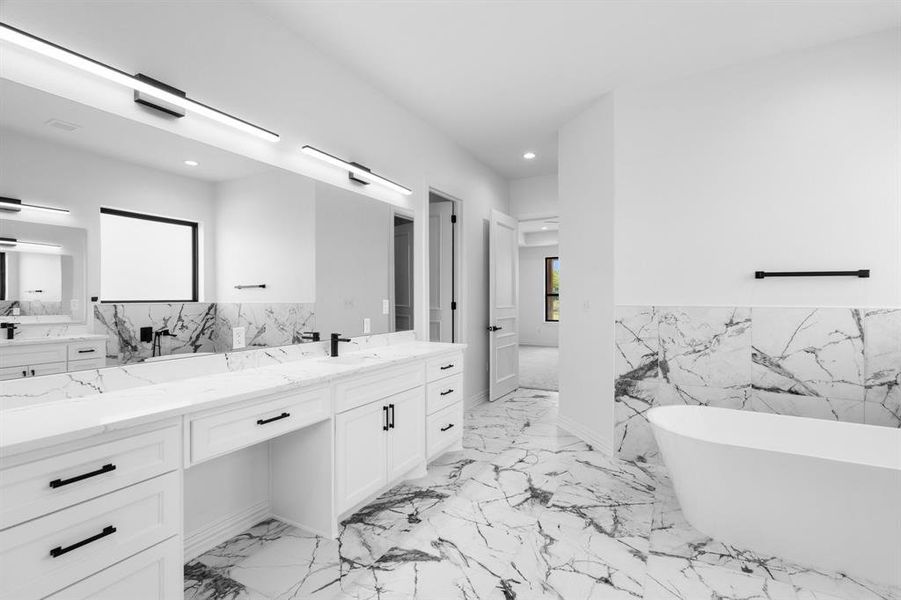 Bathroom with tile walls, vanity, a freestanding tub, recessed lighting, and plenty of natural light Bathroom with tile walls, vanity, a freestanding tub, recessed lighting, and plenty of natural light