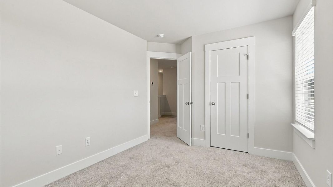 Accomplished design shines in this carpeted bedroom with a functional walk-in closet Accomplished design shines in this carpeted bedroom with a functional walk-in closet