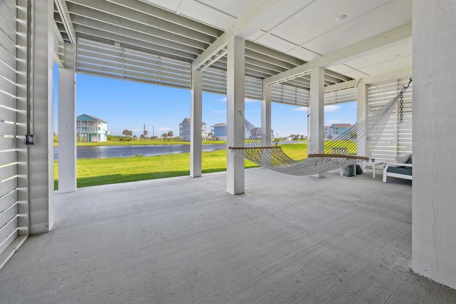 Sink into the hammock in the downstairs entertaining area, swaying gently with the sounds of the waves. Immerse yourself in the peaceful views of the lake and fountain, where every moment feels like a coastal escape.