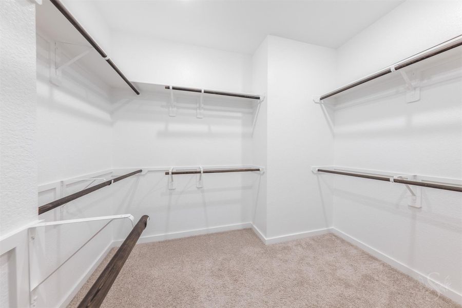 This expansive walk-in closet offers exceptional hanging space with multiple double-height rods, creating effortless organization. Bright, fresh, and thoughtfully designed, it provides the perfect backdrop for a beautifully arranged wardrobe. This expansive walk-in closet offers exceptional hanging space with multiple double-height rods, creating effortless organization. Bright, fresh, and thoughtfully designed, it provides the perfect backdrop for a beautifully arranged wardrobe.