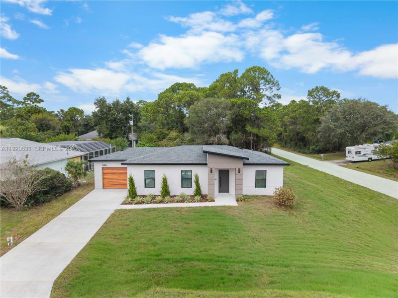 Front exterior of a new home in , Palm Bay, FL, highlighting curb appeal (Image 31). Front exterior of a new home in , Palm Bay, FL, highlighting curb appeal (Image 31).