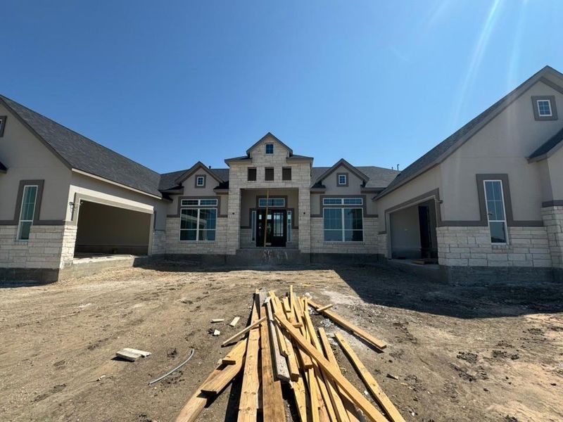 View of front facade featuring stone siding and an attached garage