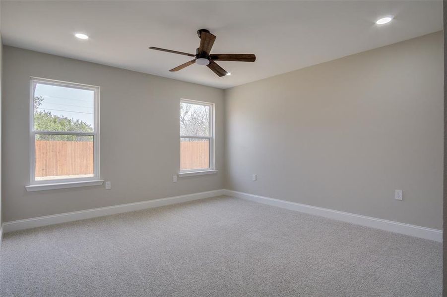 Spare room featuring recessed lighting, baseboards, light colored carpet, and ceiling fan