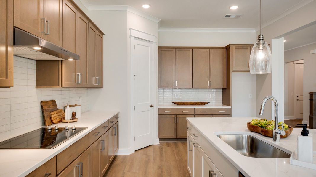Sink and dishwasher paired with kitchen island next to staircase Sink and dishwasher paired with kitchen island next to staircase