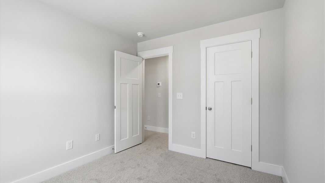 Notable secondary bedroom offering cozy carpeted flooring and a stylish walk-in closet in Anderson, SC Notable secondary bedroom offering cozy carpeted flooring and a stylish walk-in closet in Anderson, SC