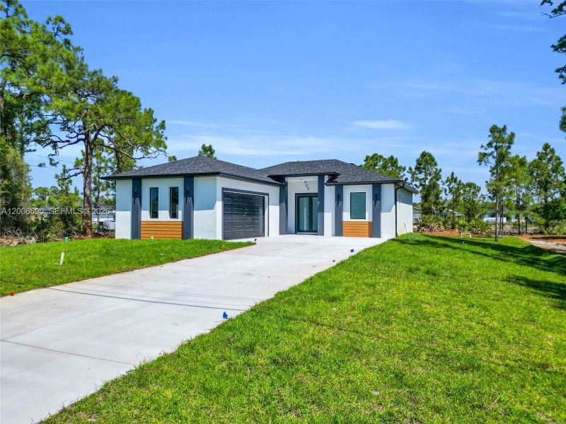 Front exterior of a new home in , Lehigh Acres, FL, highlighting curb appeal (Image 26).