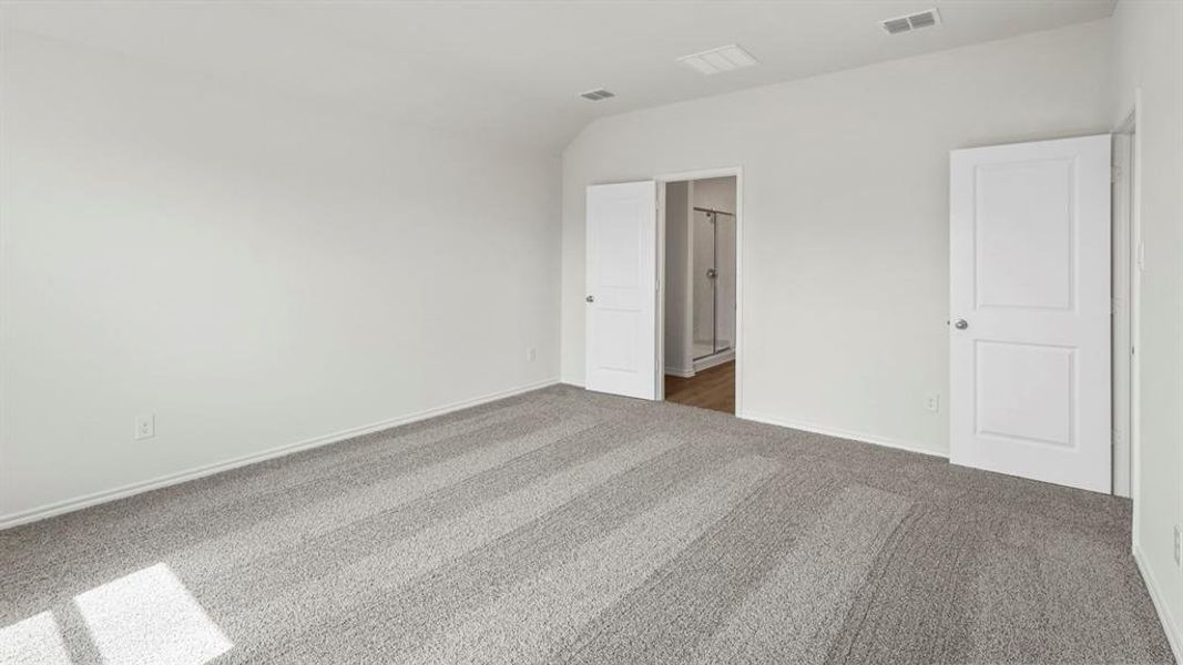 This expansive room features light gray carpet flooring and white walls, creating a bright and airy atmosphere