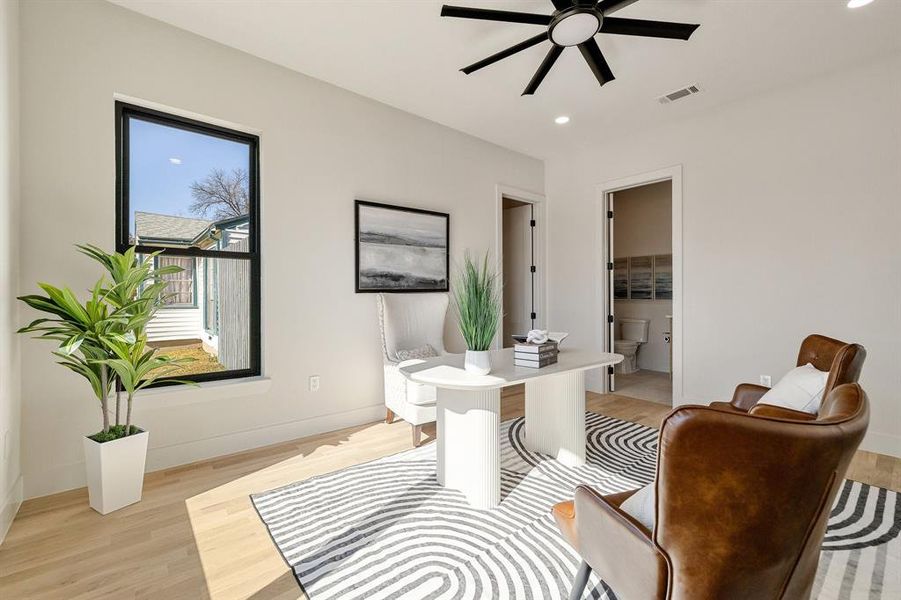 Sitting room with light hardwood / wood-style flooring and ceiling fan