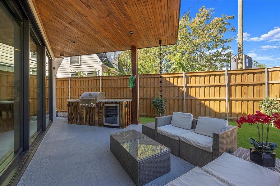 View of patio featuring a grill, area for grilling, beverage cooler, and outdoor lounge area