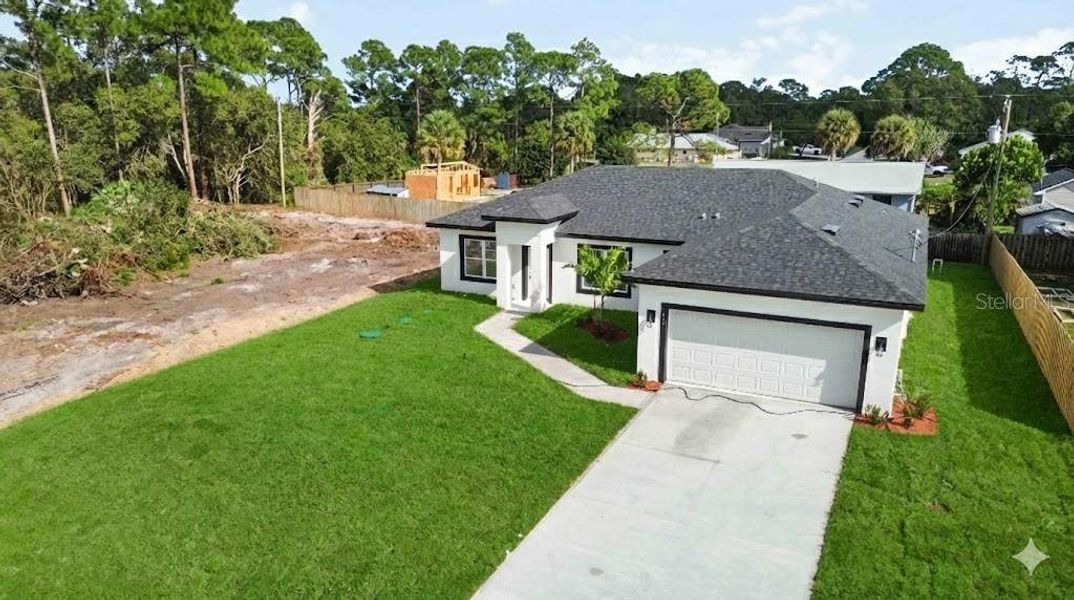 Front exterior of a new home in , Palm Bay, FL, highlighting curb appeal (Image 1). Front exterior of a new home in , Palm Bay, FL, highlighting curb appeal (Image 1).