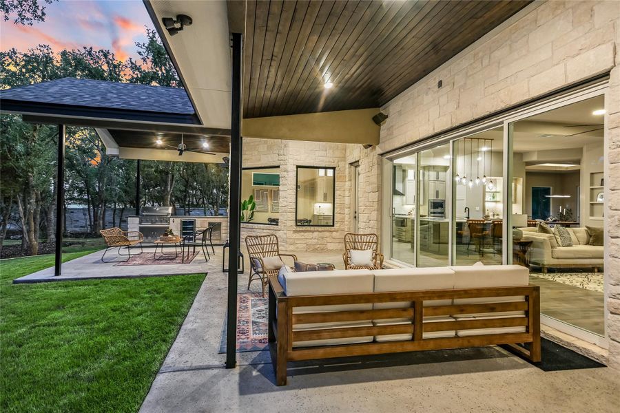 Patio terrace at dusk featuring an outdoor living space, a patio area, a grill, a yard, and ceiling fan Patio terrace at dusk featuring an outdoor living space, a patio area, a grill, a yard, and ceiling fan
