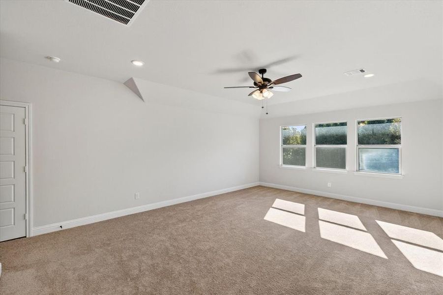 Empty room featuring recessed lighting, light colored carpet, and a ceiling fan Empty room featuring recessed lighting, light colored carpet, and a ceiling fan