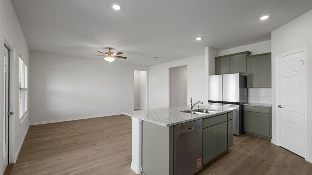Open-concept living space featuring wood-finish flooring, recessed lighting, and a ceiling fan