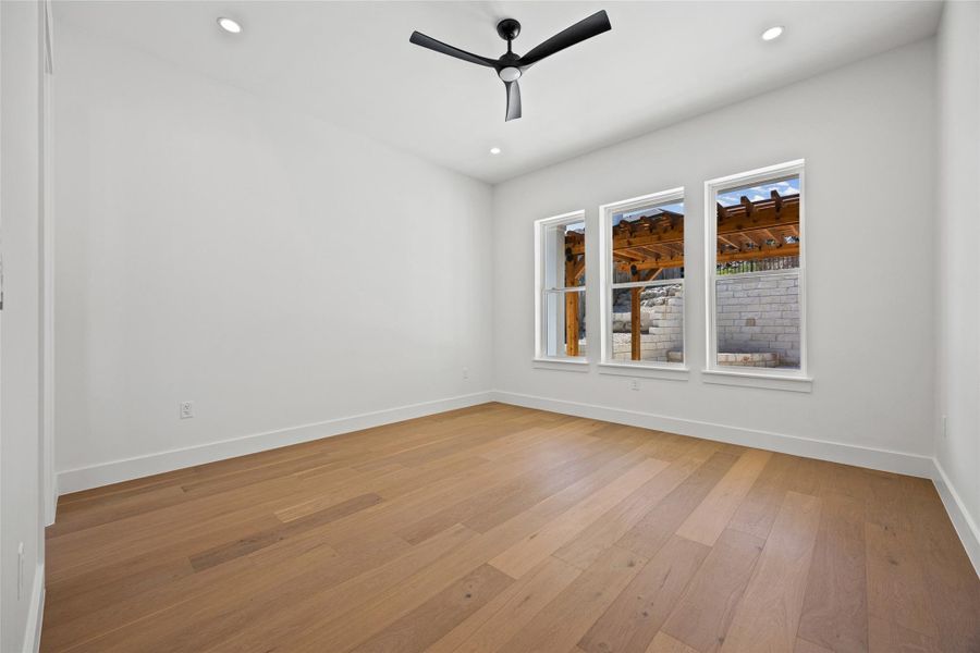 Unfurnished room featuring light wood-style floors, ceiling fan, and recessed lighting Unfurnished room featuring light wood-style floors, ceiling fan, and recessed lighting