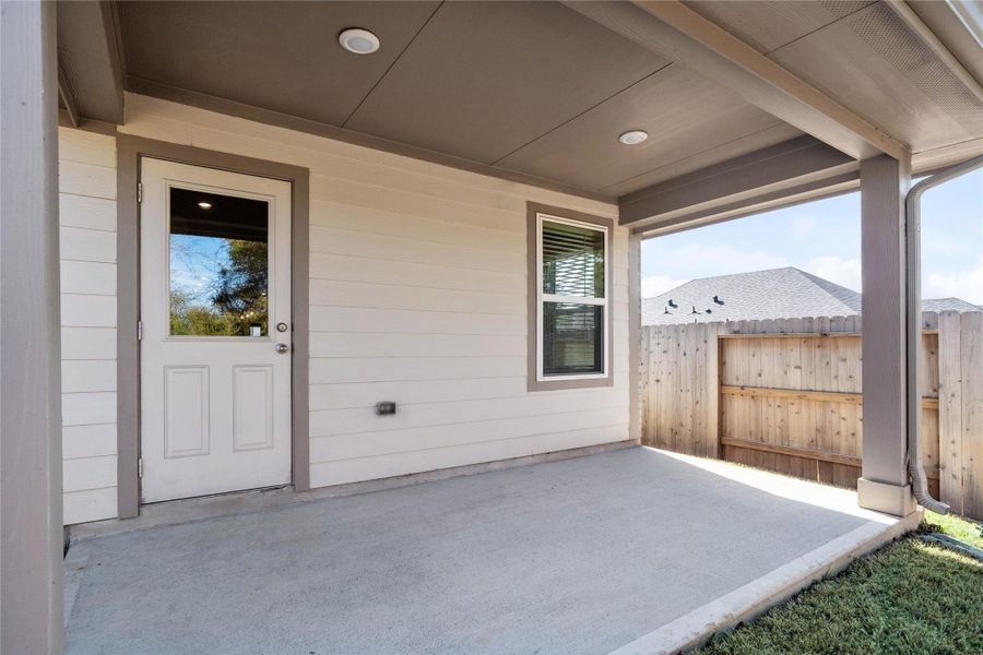 The spacious covered patio offers a tranquil outdoor retreat, perfectly designed for savoring your quiet morning coffee or unwinding during peaceful evening relaxation.