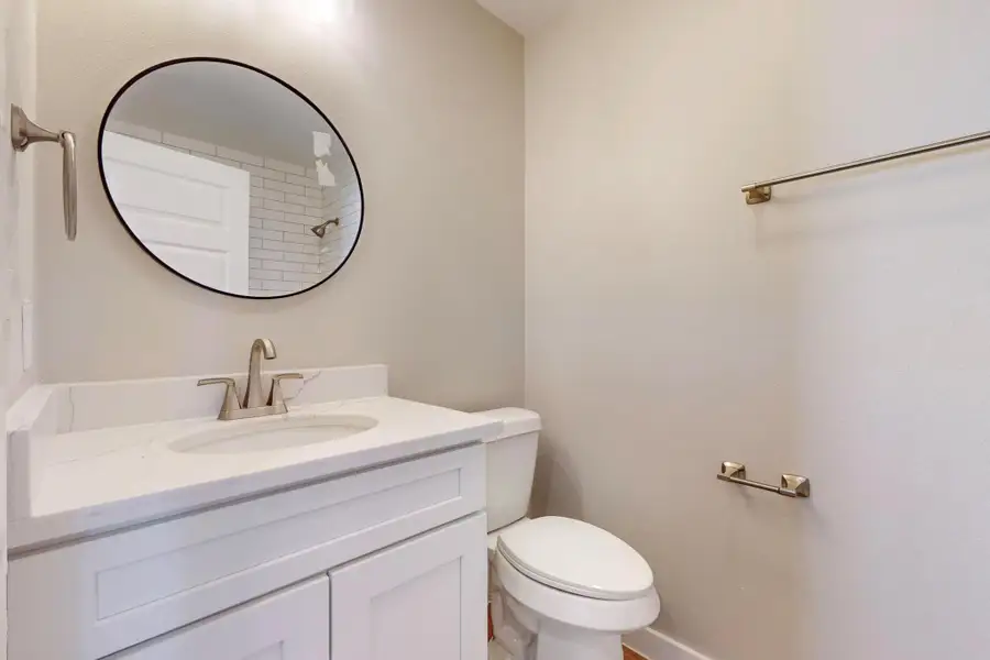 Hall bathroom featuring vanity and toilet