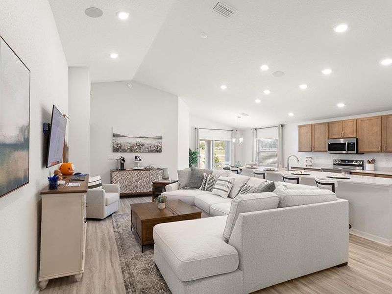 Enjoy a bright, open living area with LVP flooring. Photos showcase a home with similar finishes, not the actual home for sale.