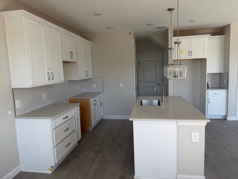 Kitchen features a large kitchen island and ample cabinetry Kitchen features a large kitchen island and ample cabinetry