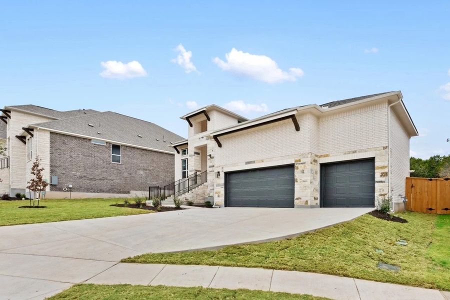 Front exterior of a new home in The Estates at La Cima, San Marcos, TX, highlighting curb appeal (Image 24).