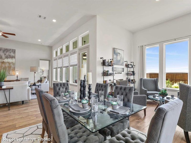 Dining space with recessed lighting, plenty of natural light, light wood-style floors, and a ceiling fan Dining space with recessed lighting, plenty of natural light, light wood-style floors, and a ceiling fan