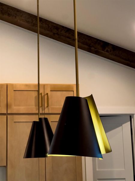 Rich wood cabinetry complements the architectural character of rustic ceiling beams overhead. Rich wood cabinetry complements the architectural character of rustic ceiling beams overhead.